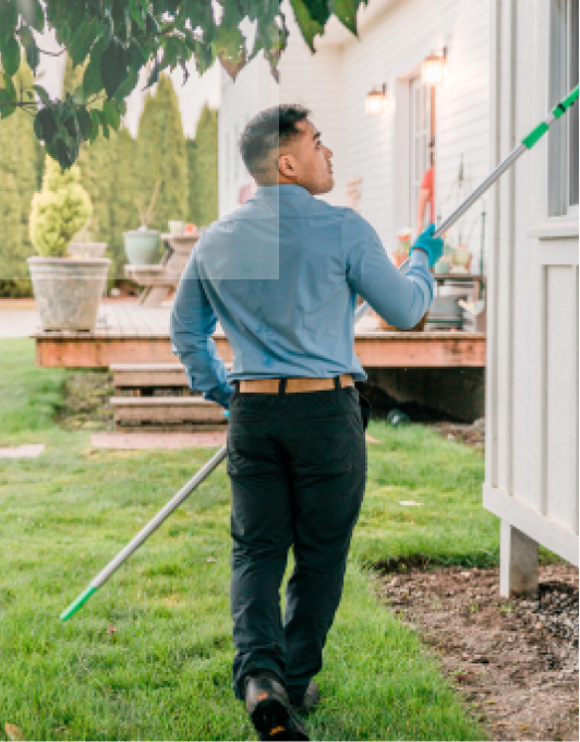 Pest control technician dusting home