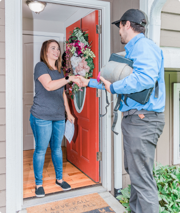 Pest control technician talking to a customer