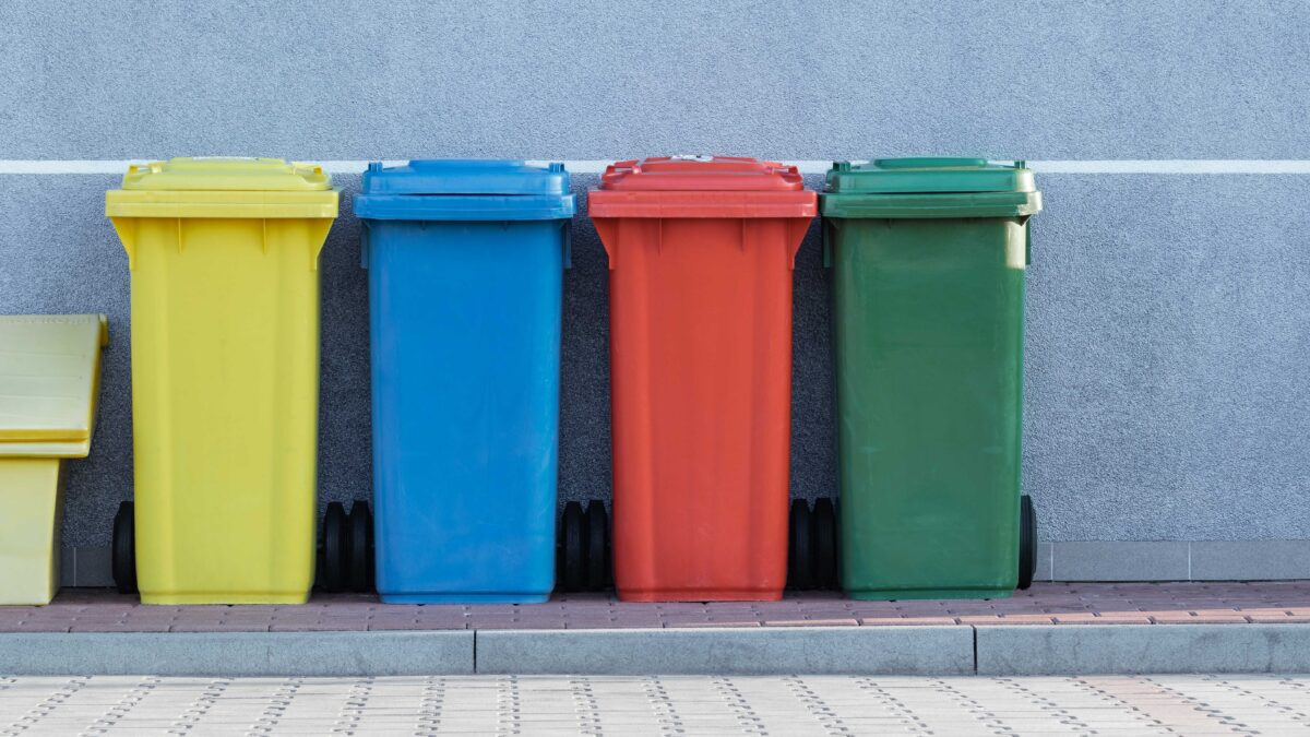 Garbage cans lined up on a curb