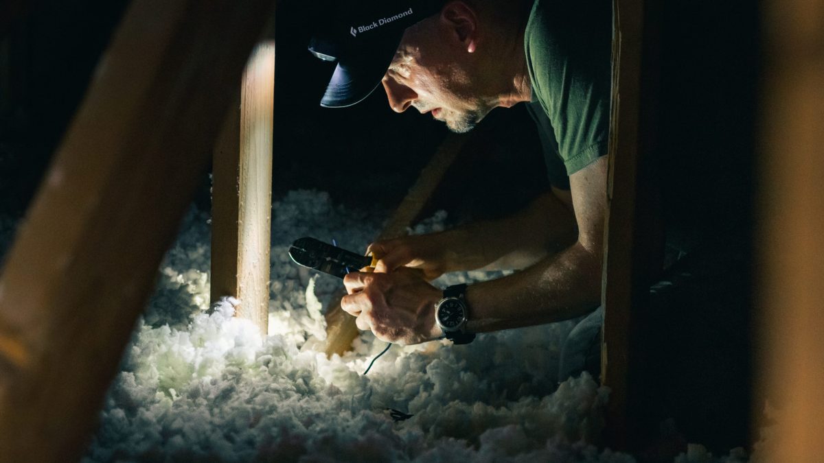 Pest control technician in attic