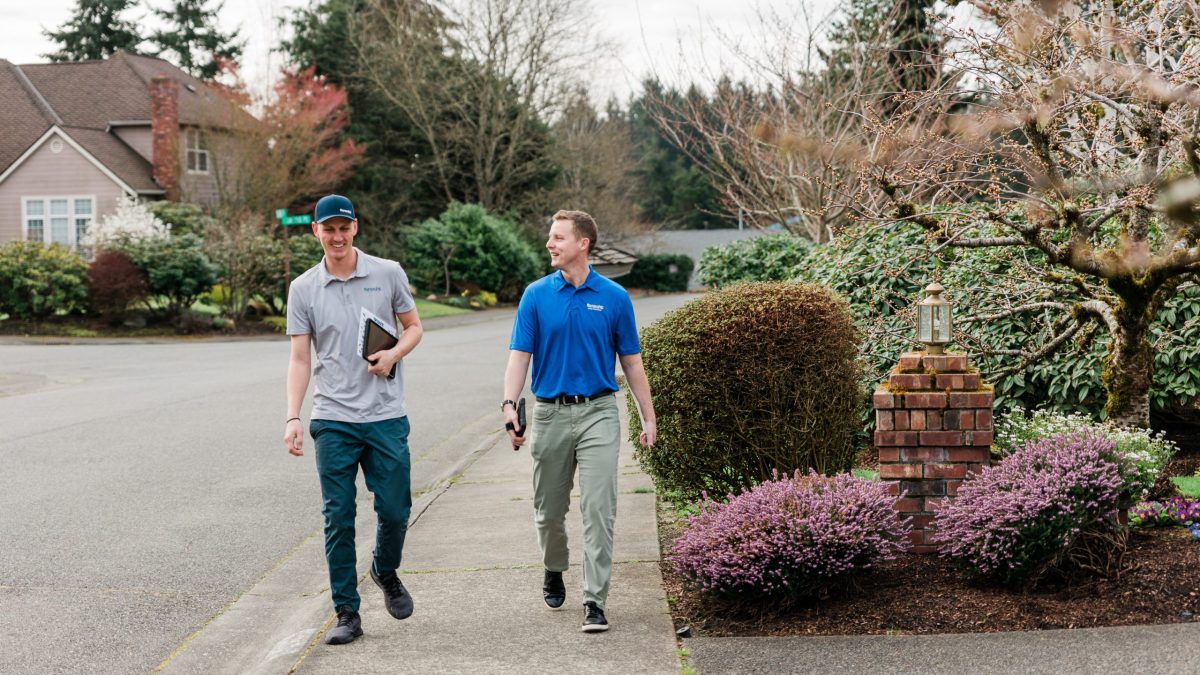 Insight Pest Control technicians walking down sidewalk